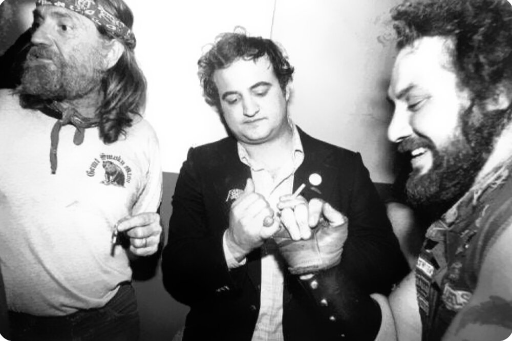 Willie Nelson and John Belushi at a SNL afterparty 1970 2.jpg